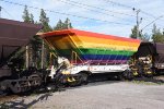 LKAB ore open top hopper car in LGBT colors